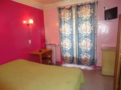 Un ou plusieurs lits dans un hébergement de l'établissement Hotel des Belges