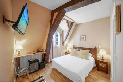 Un ou plusieurs lits dans un hébergement de l'établissement Hotel de la Bretonnerie