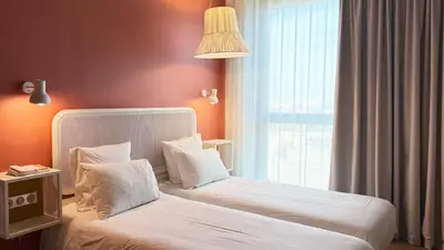 Un ou plusieurs lits dans un hébergement de l'établissement OKKO Hotels Paris Gare de l'Est