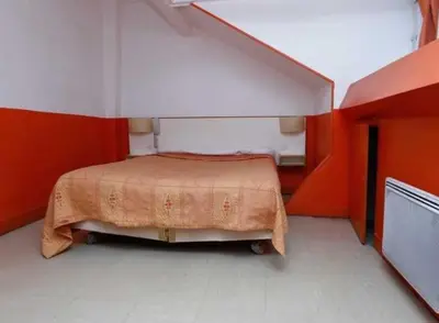 Un ou plusieurs lits dans un hébergement de l'établissement Hôtel du Pont Neuf