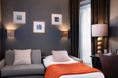 Un ou plusieurs lits dans un hébergement de l'établissement Hôtel Plaza Étoile