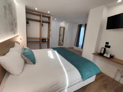 Un ou plusieurs lits dans un hébergement de l'établissement 55 Hôtel Montparnasse