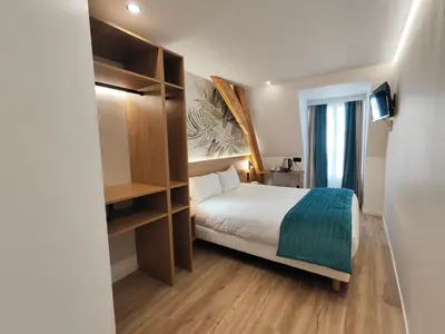 Un ou plusieurs lits dans un hébergement de l'établissement 55 Hôtel Montparnasse