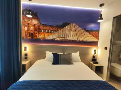 Un ou plusieurs lits dans un hébergement de l'établissement 55 Hôtel Montparnasse