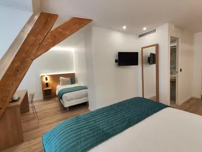 Un ou plusieurs lits dans un hébergement de l'établissement 55 Hôtel Montparnasse
