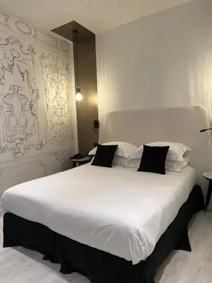 Un ou plusieurs lits dans un hébergement de l'établissement Hotel Massena
