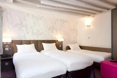 Un ou plusieurs lits dans un hébergement de l'établissement Hotel Massena