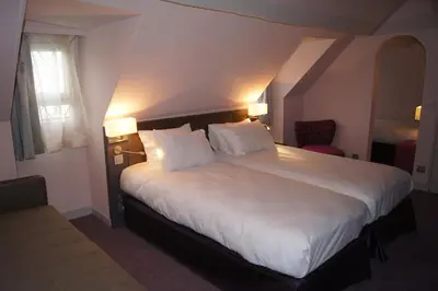 Un ou plusieurs lits dans un hébergement de l'établissement Hotel Massena