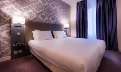 Un ou plusieurs lits dans un hébergement de l'établissement Hotel Massena