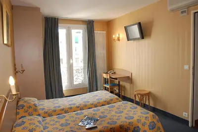 Un ou plusieurs lits dans un hébergement de l'établissement Hôtel Transcontinental