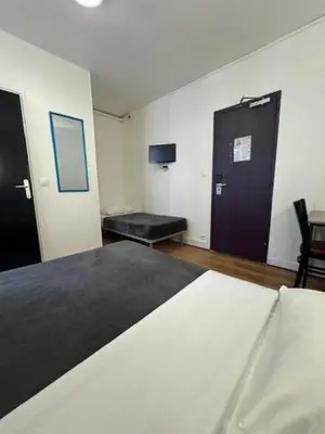Un ou plusieurs lits dans un hébergement de l'établissement Hotel Chevallier