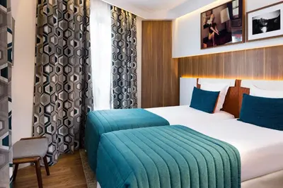 Un ou plusieurs lits dans un hébergement de l'établissement Hôtel Eiffel Turenne