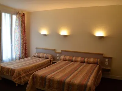 Un ou plusieurs lits dans un hébergement de l'établissement Hotel des Vosges
