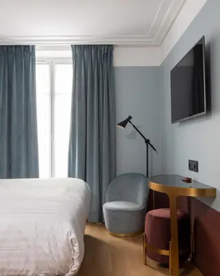 Un ou plusieurs lits dans un hébergement de l'établissement Hôtel Parisianer