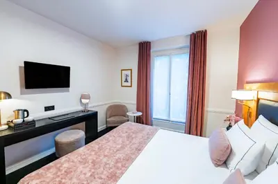 Un ou plusieurs lits dans un hébergement de l'établissement Hôtel Le Cercle Tour Eiffel