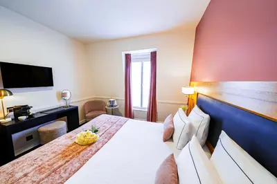 Un ou plusieurs lits dans un hébergement de l'établissement Hôtel Le Cercle Tour Eiffel