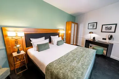 Un ou plusieurs lits dans un hébergement de l'établissement Hôtel Le Cercle Tour Eiffel