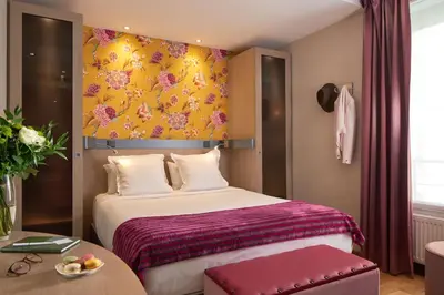 Un ou plusieurs lits dans un hébergement de l'établissement Hôtel Tourisme Avenue