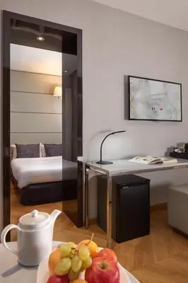 Un ou plusieurs lits dans un hébergement de l'établissement Hôtel Tourisme Avenue