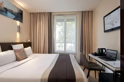 Un ou plusieurs lits dans un hébergement de l'établissement Hôtel Tourisme Avenue