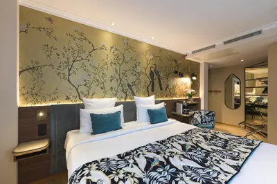 Un ou plusieurs lits dans un hébergement de l'établissement Hôtel Tourisme Avenue