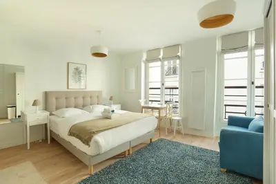 Un ou plusieurs lits dans un hébergement de l'établissement Résidence Grands Boulevards by Studio prestige