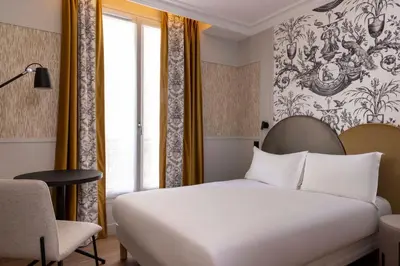 Un ou plusieurs lits dans un hébergement de l'établissement Grand Hôtel Lévêque