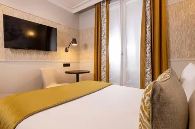 Un ou plusieurs lits dans un hébergement de l'établissement Grand Hôtel Lévêque