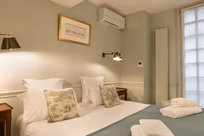 Un ou plusieurs lits dans un hébergement de l'établissement Pick A Flat's Apartments in Saint Germain - Paul-Louis Courier