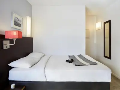 Un ou plusieurs lits dans un hébergement de l'établissement Aparthotel Adagio Access Paris Bastille