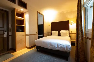 Un ou plusieurs lits dans un hébergement de l'établissement Hôtel Relais Monceau