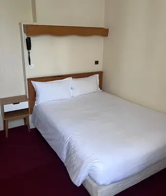 Un ou plusieurs lits dans un hébergement de l'établissement Hotel Paris Bercy