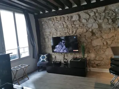 Télévision ou salle de divertissement dans l'établissement Appartement St Martin