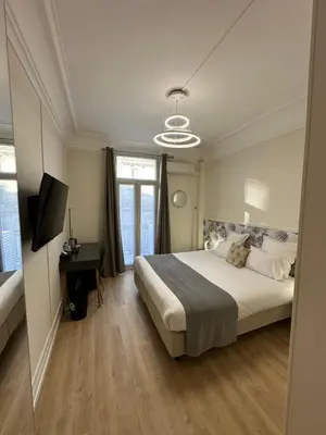 Un ou plusieurs lits dans un hébergement de l'établissement Hôtel Océanic - Grands Magasins