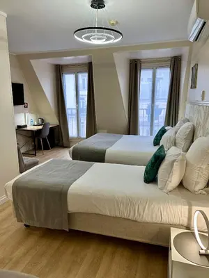 Un ou plusieurs lits dans un hébergement de l'établissement Hôtel Océanic - Grands Magasins