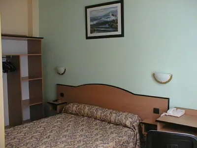 Un ou plusieurs lits dans un hébergement de l'établissement Hotel Ferney République