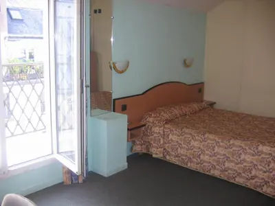 Un ou plusieurs lits dans un hébergement de l'établissement Hotel Ferney République