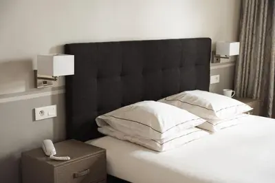 Un ou plusieurs lits dans un hébergement de l'établissement Hôtel Eiffel Segur
