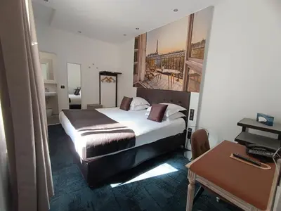 Un ou plusieurs lits dans un hébergement de l'établissement Hotel Aida Marais