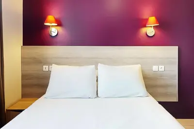 Un ou plusieurs lits dans un hébergement de l'établissement Hôtel de Ménilmontant