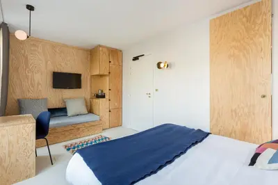 Un ou plusieurs lits dans un hébergement de l'établissement Hôtel Montholon