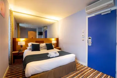 Un ou plusieurs lits dans un hébergement de l'établissement Hôtel Pavillon Bastille