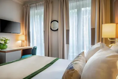 Un ou plusieurs lits dans un hébergement de l'établissement Hôtel Le Tourville by Inwood Hotels