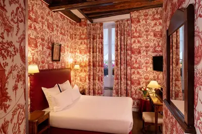Un ou plusieurs lits dans un hébergement de l'établissement Relais Hôtel du Vieux Paris