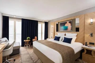 Un ou plusieurs lits dans un hébergement de l'établissement Hotel Louvre Saint-Honoré