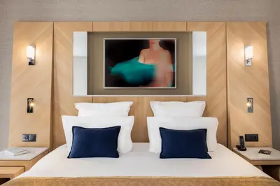 Un ou plusieurs lits dans un hébergement de l'établissement Hotel Louvre Saint-Honoré