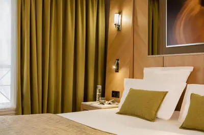 Un ou plusieurs lits dans un hébergement de l'établissement Hotel Louvre Saint-Honoré