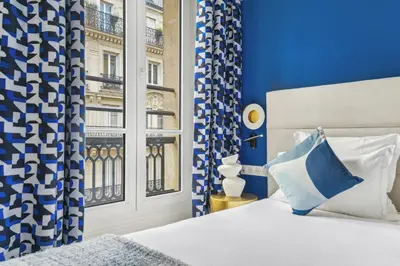 Un ou plusieurs lits dans un hébergement de l'établissement Hotel Elysees Opera