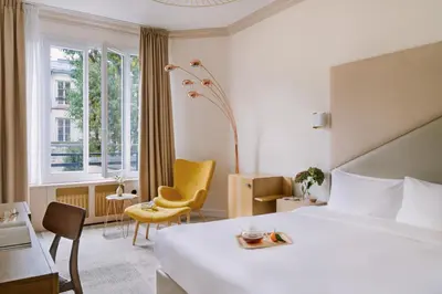 Un ou plusieurs lits dans un hébergement de l'établissement Hôtel Atala Champs Elysees