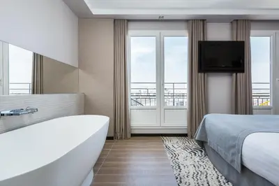Un ou plusieurs lits dans un hébergement de l'établissement Hôtel Atala Champs Elysees
